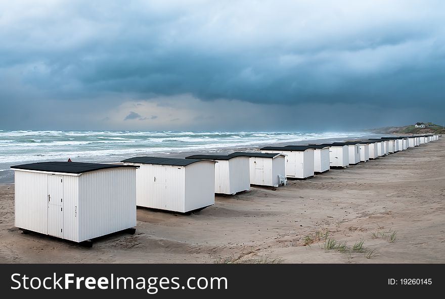 Row of  many beach houses in Loekken during a summer storm