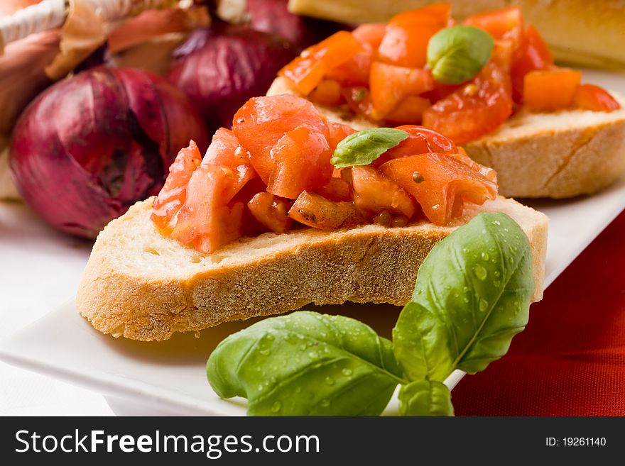 Photo of delicious italian bruschetta with basil and ingredients. Photo of delicious italian bruschetta with basil and ingredients