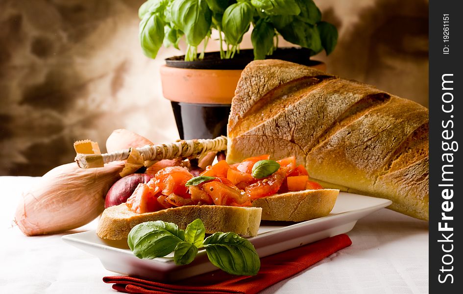 Photo of delicious italian bruschetta with basil and ingredients. Photo of delicious italian bruschetta with basil and ingredients