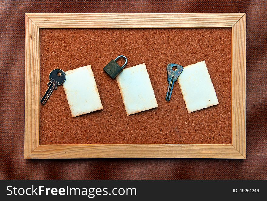 Cork board with 3 old white paper clip by old key