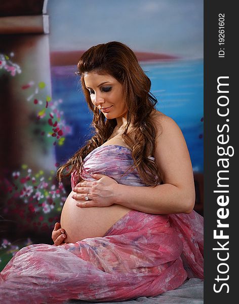 Close-up of a pregnant woman holding her stomach