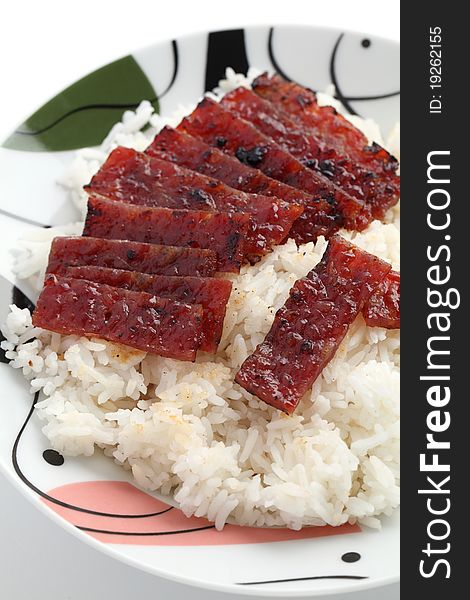 Close up of barbecue meat rice on white plate isolated over white background.