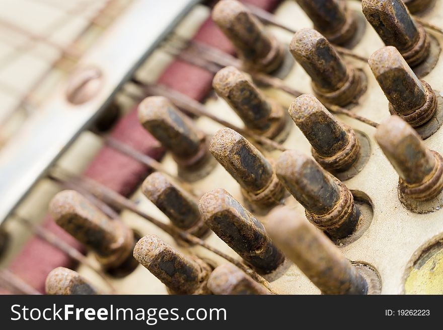 Close-up, rusty frets, old piano