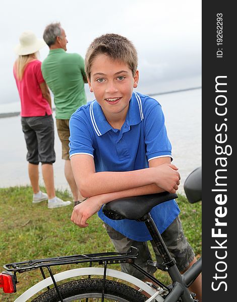 Portrait of young boy leaning on bicycle. Portrait of young boy leaning on bicycle