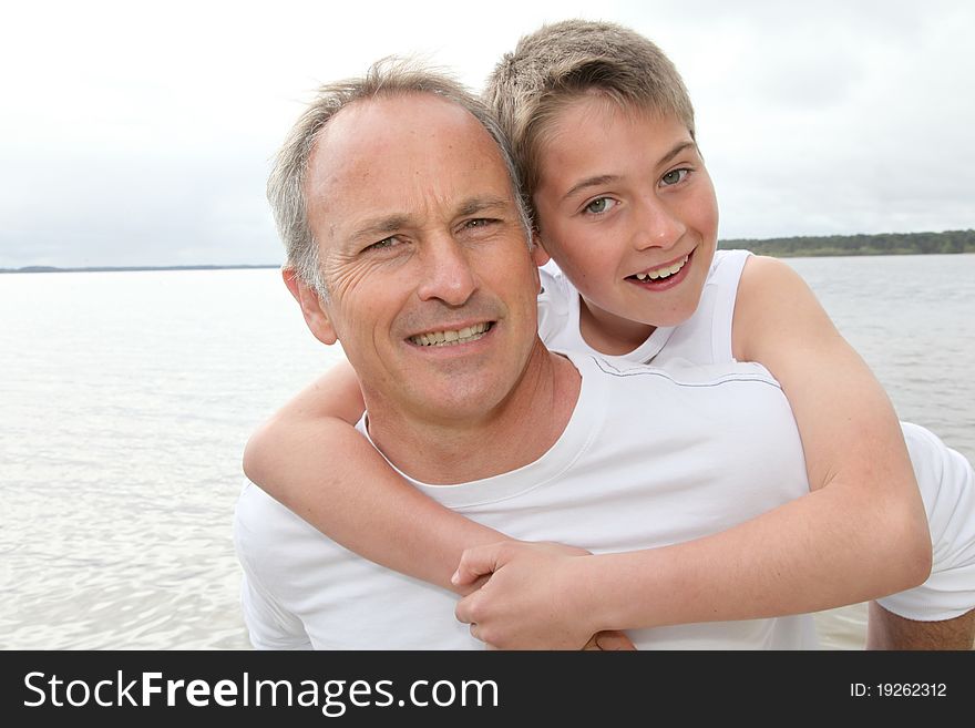 Portrait of men carrying young boy on his back. Portrait of men carrying young boy on his back