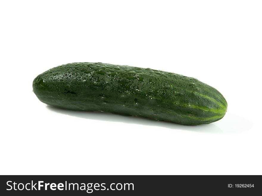 A single green isolated cucumber with shadow. A single green isolated cucumber with shadow.