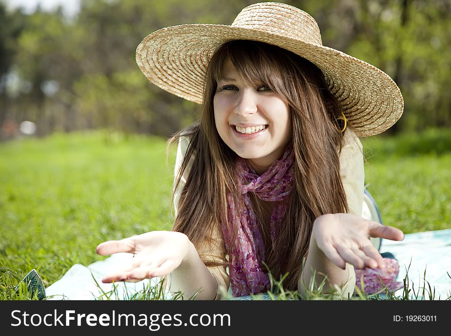 Beautiful brunette girl in hat at the park