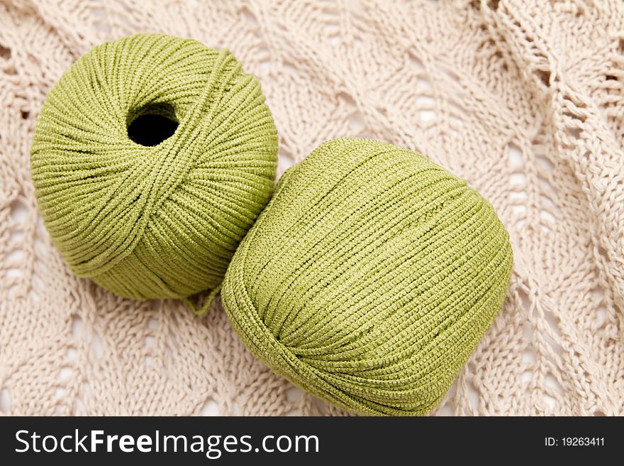 Two green yarn skeins on the cloth