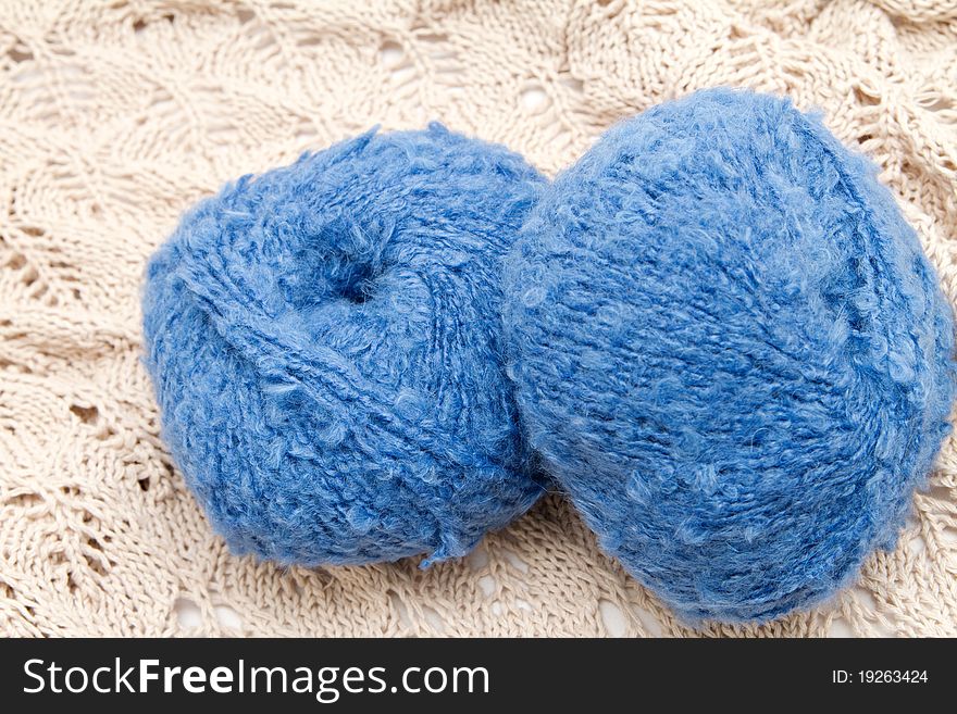 Two blue yarn skeins on the cloth. Two blue yarn skeins on the cloth