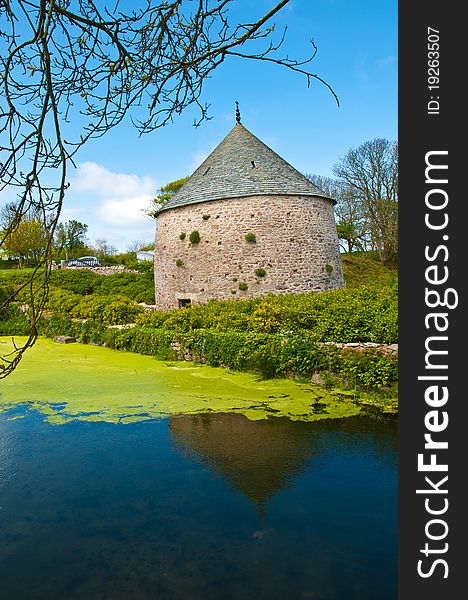 Small old house with a cylindrical roof with a pond infront, photographed in Northern France. Small old house with a cylindrical roof with a pond infront, photographed in Northern France.