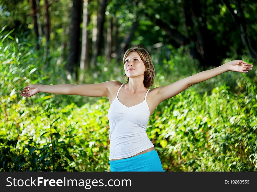 The image of a beautiful girl in a summer forest