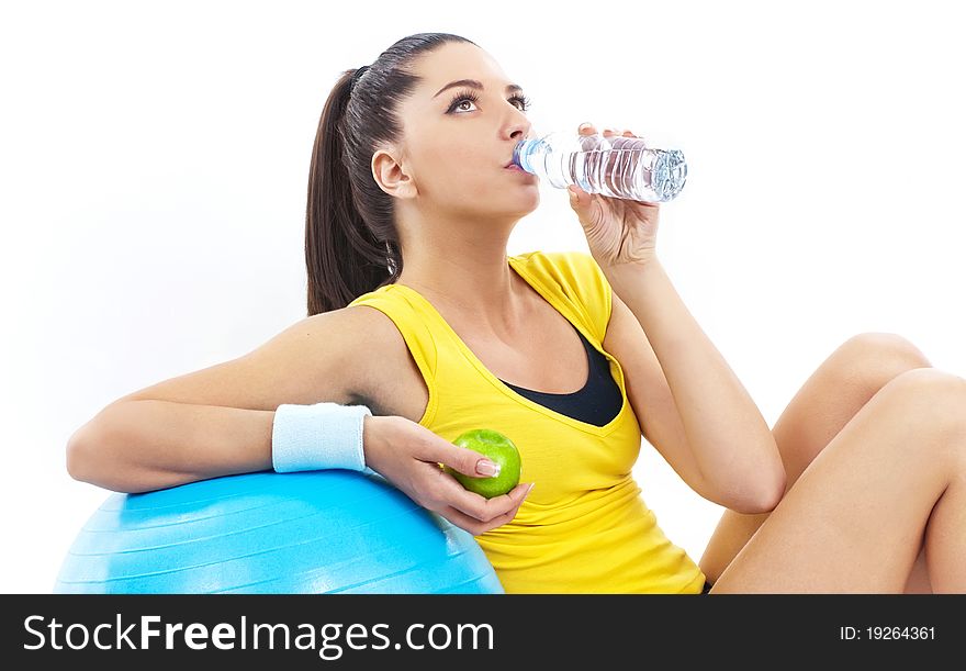 Women drinking water and holding apple. Women drinking water and holding apple