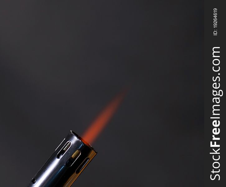 Flame shoting out of a torch with smoke background. Flame shoting out of a torch with smoke background