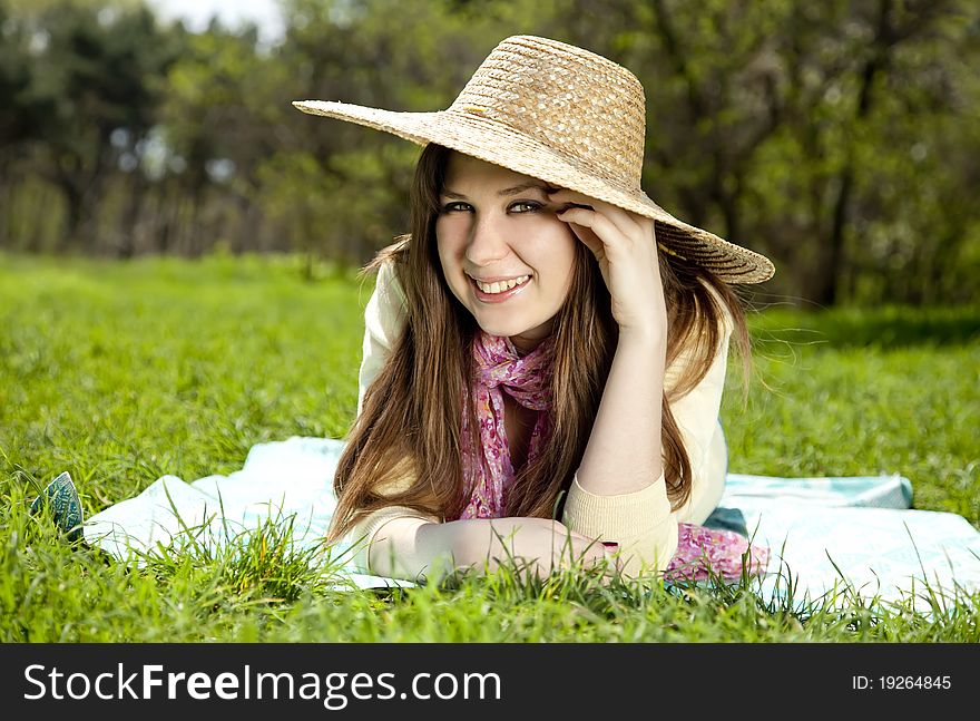 Beautiful brunette girl in hat at the park.