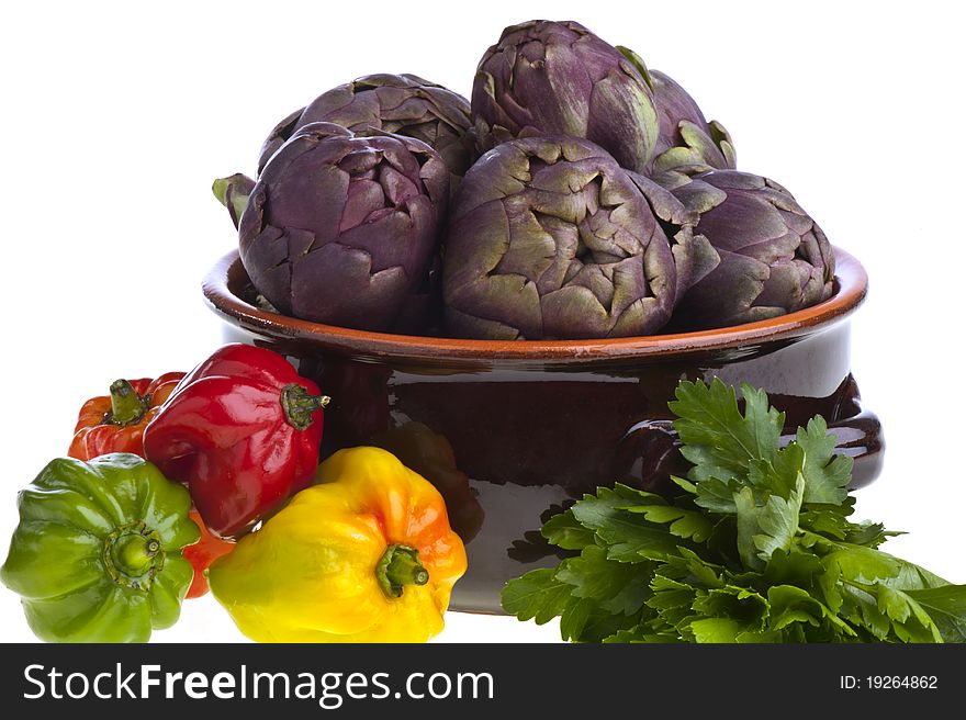 Small exotic peppers and artichokes on a white background