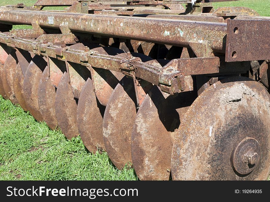 Abandoned, rusty, agricoltural machine in a field. Abandoned, rusty, agricoltural machine in a field