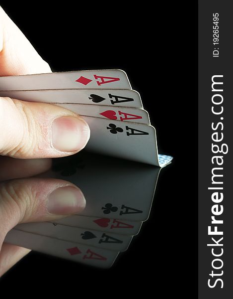 Four aces in poker isolated on a black background