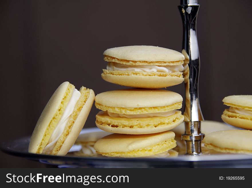 A plate of yellow macarons made for Easter. Filling inside is a cream cheese frosting with lemon tast. A plate of yellow macarons made for Easter. Filling inside is a cream cheese frosting with lemon tast.