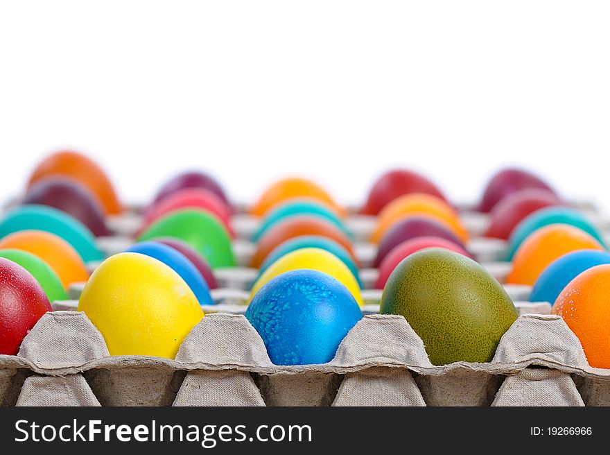 Colorful easter eggs in carton isolated on white background