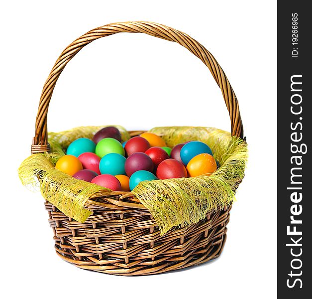 Easter eggs in basket with white lily on white background