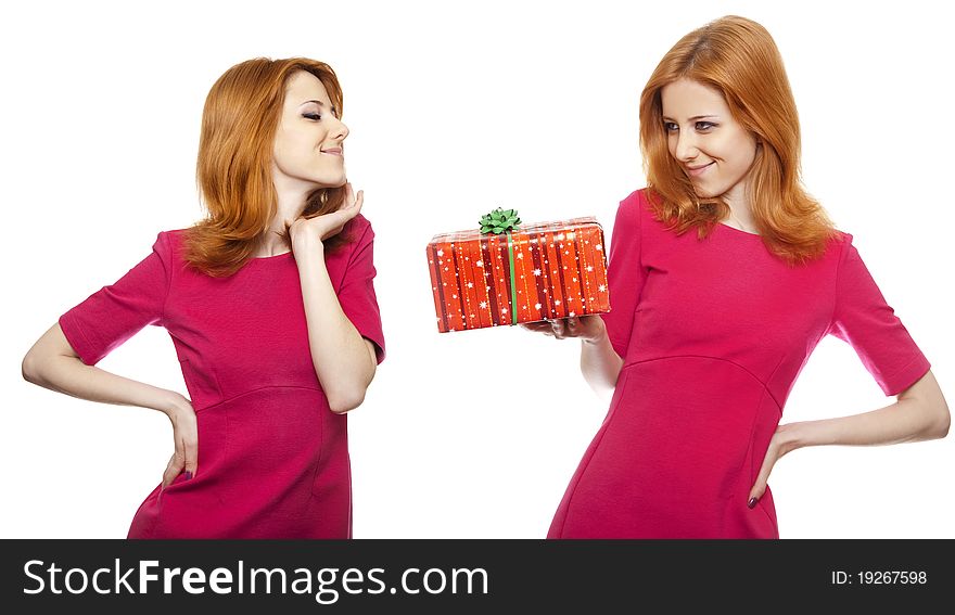 Two girls, one of them with presetn box. Studio shot.