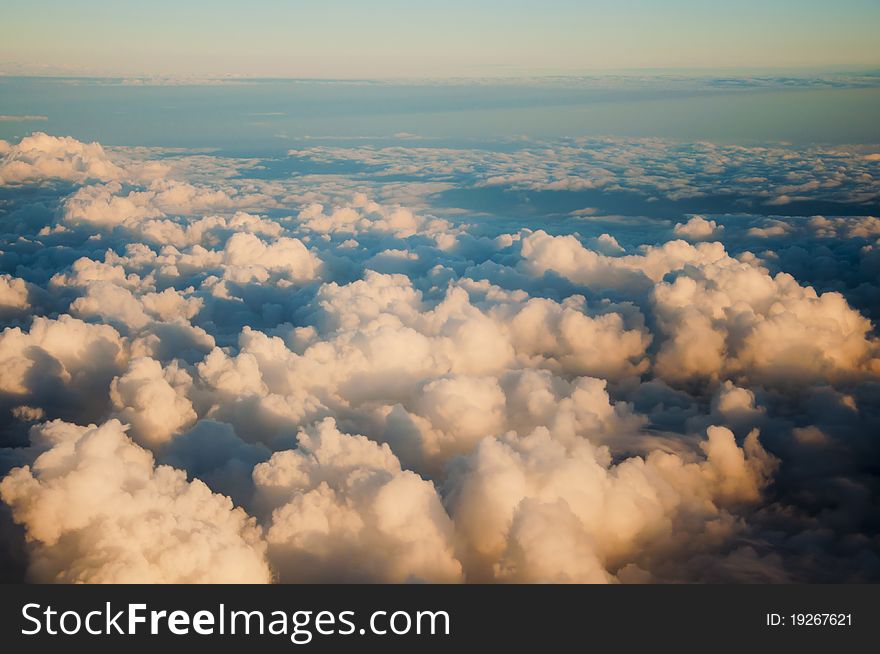 A photograph takem from above the clouds showing a variety of different cloud formations. A photograph takem from above the clouds showing a variety of different cloud formations.