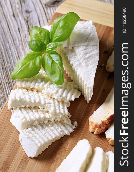 Slices of feta cheese on a cutting board