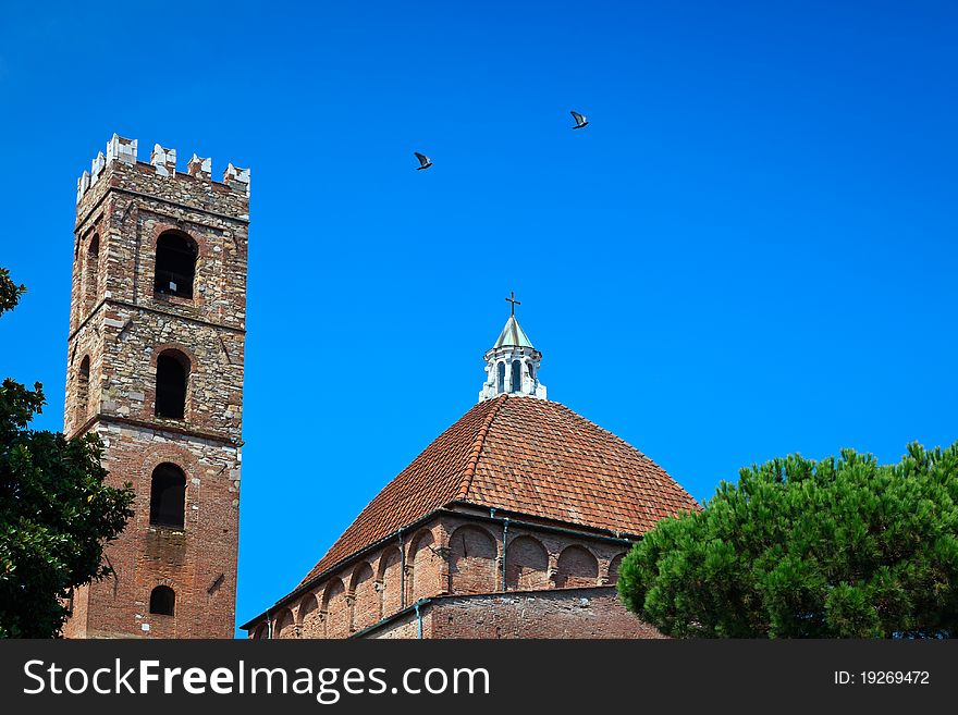 Church dome and bell tower against clear, blue sky.