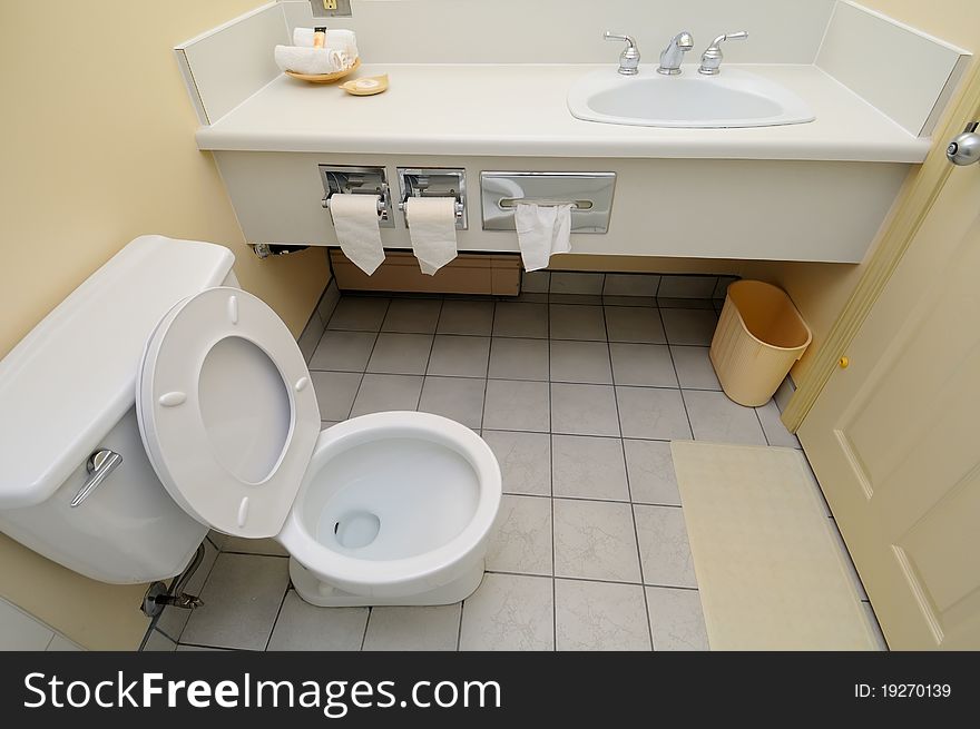 Bright and white toilet area and wash basin.