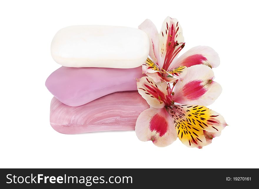 Three pieces of  pink and white soap and orchid