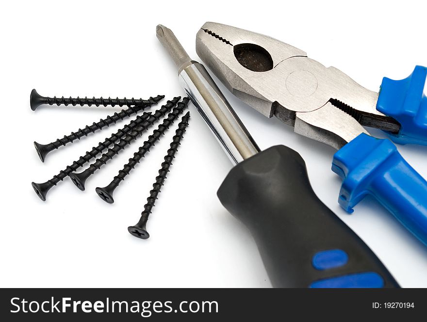 Screwdriver and pliers on a white background