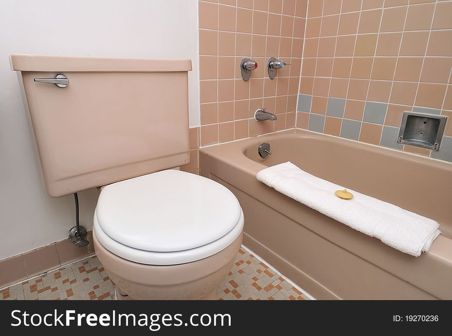 Simple interior view of clean toilet with bathtub. Simple interior view of clean toilet with bathtub.