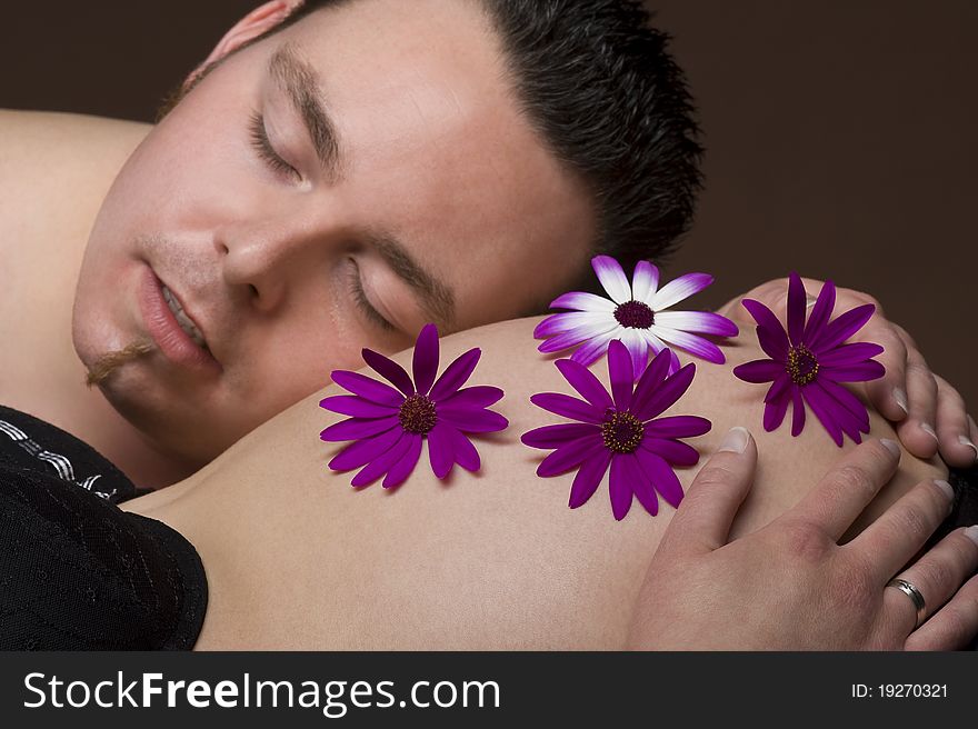 A pregnant woman with blossoms on her belly