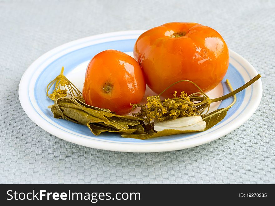 Red tomatoes on a plate with a blue bordered