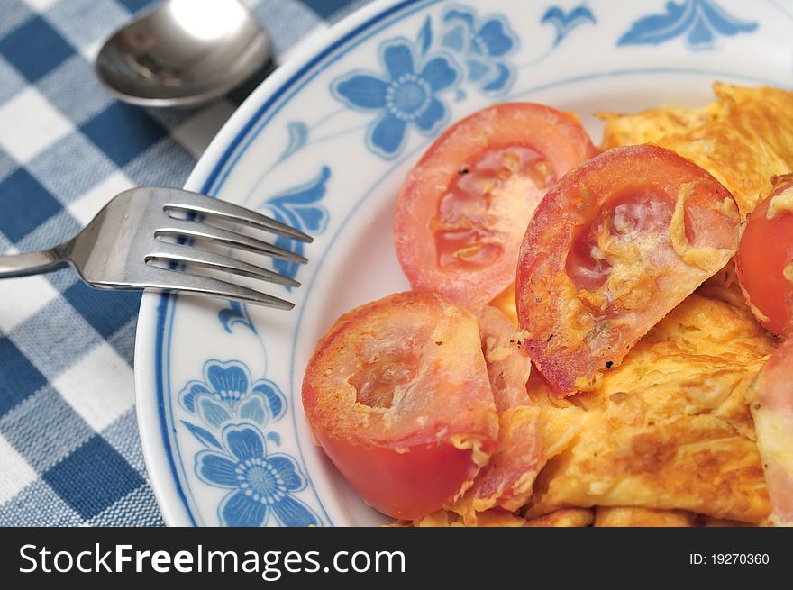 Chinese style egg omelet fried with fresh raw tomatoes. Chinese style egg omelet fried with fresh raw tomatoes.