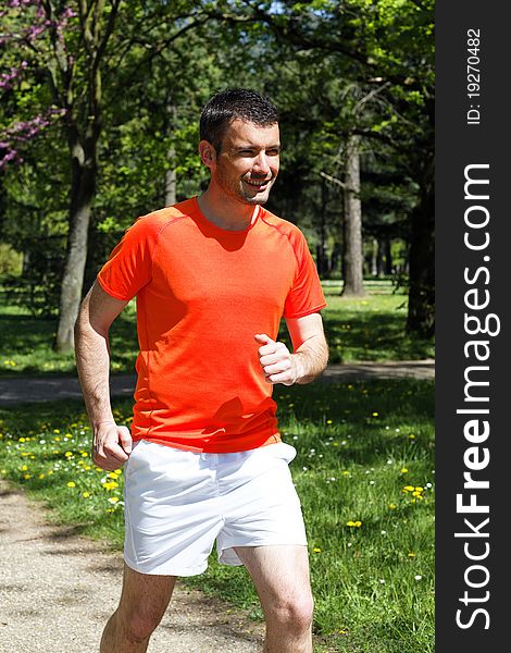 Man running in a park on spring. Man running in a park on spring