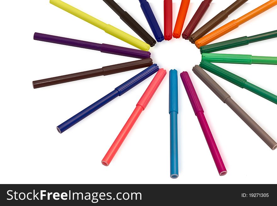 Multi-colored markers in the form of the sun on a white background