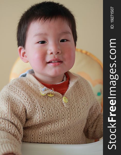 Cute and lovely chinese boy sitting on the baby chair. Cute and lovely chinese boy sitting on the baby chair