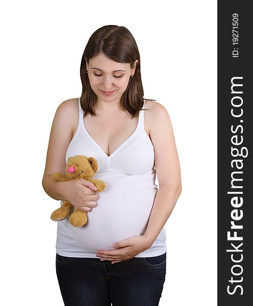 Smiling young pregnant woman with teddy bear