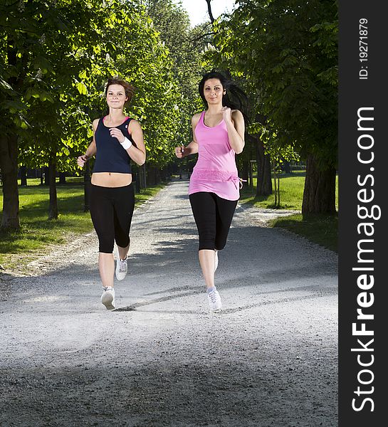 Young girls jogging running in the park. Young girls jogging running in the park