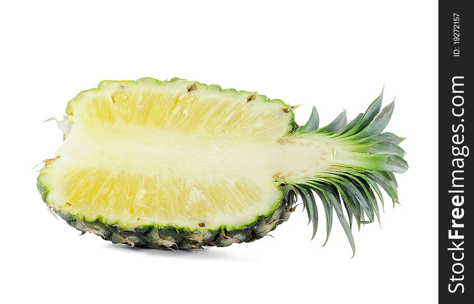 Fresh pineapple with cut and green leaves isolated on white background