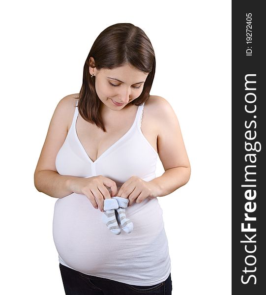 Smiling young pregnant woman  with blue striped baby socks