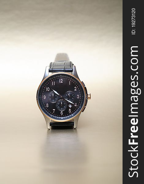 Modern wristwatch standing on nice silver background. Modern wristwatch standing on nice silver background