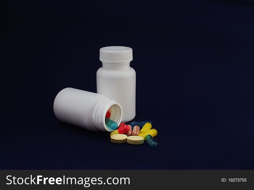 Colorful capsules and pills with packaging on pure backround. Colorful capsules and pills with packaging on pure backround