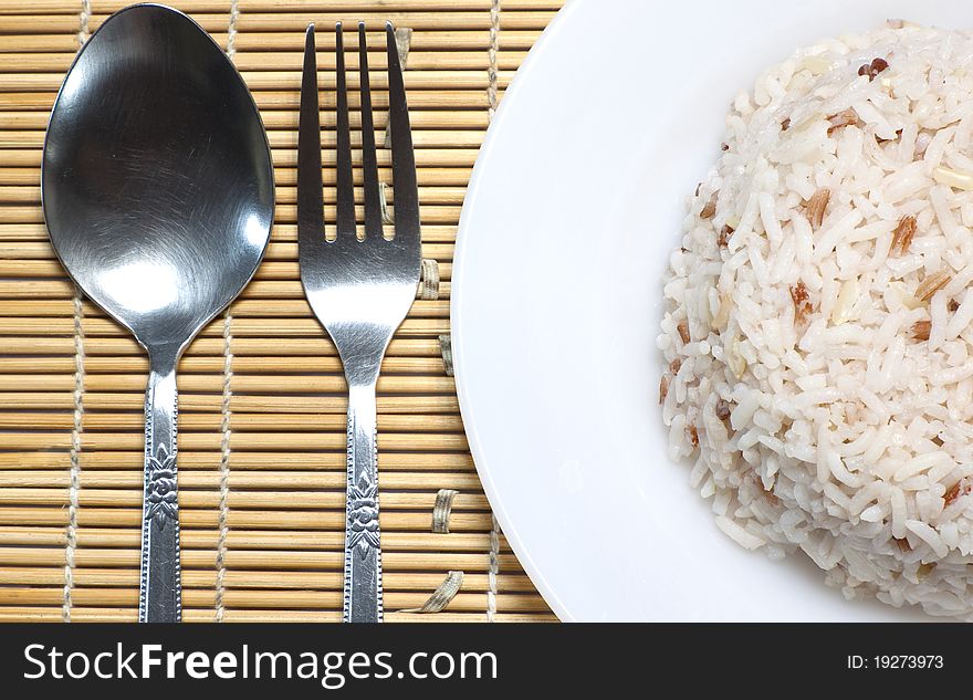 Steam rice with spoon and fork that is the traditional asian meal