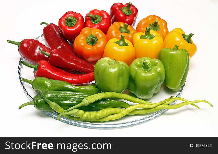 Three colored peppers on white background