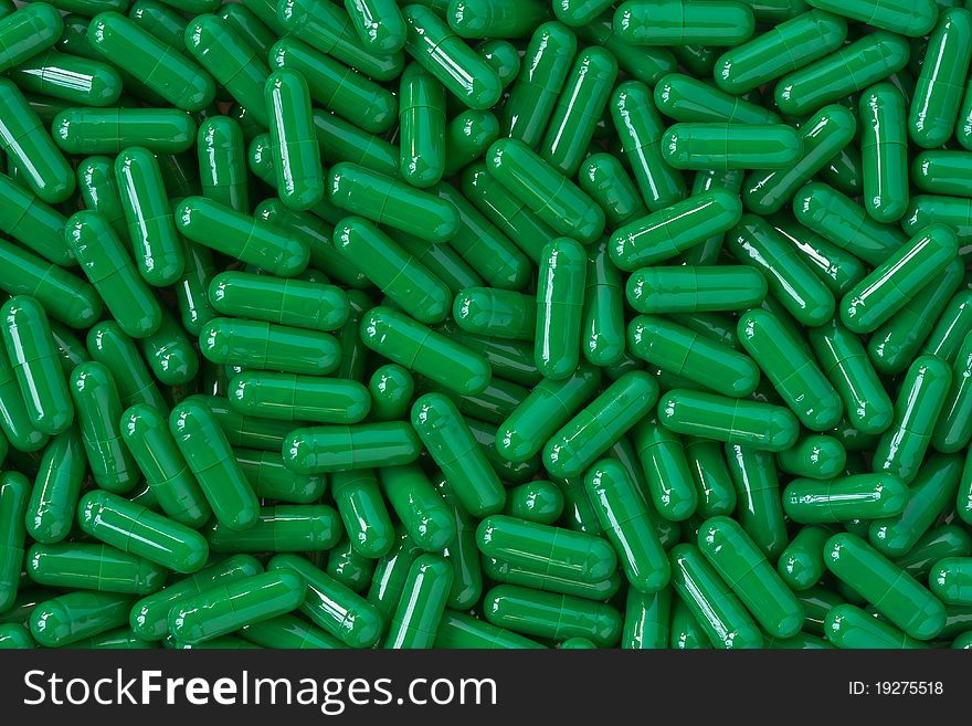 Many green capsule pills background