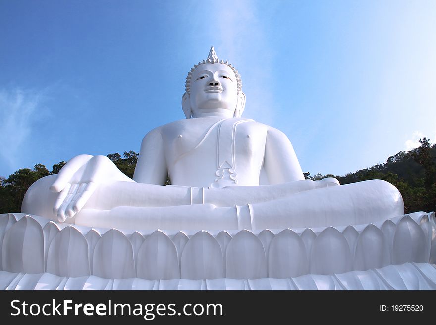 White Buddha on the mountain with blue sky. White Buddha on the mountain with blue sky