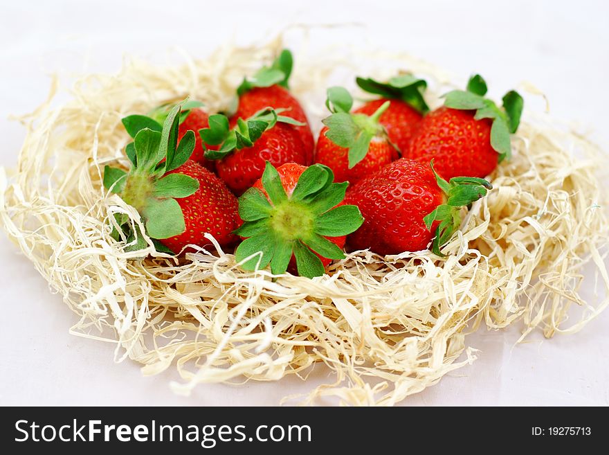 Strawberries In The Hay On A White Background