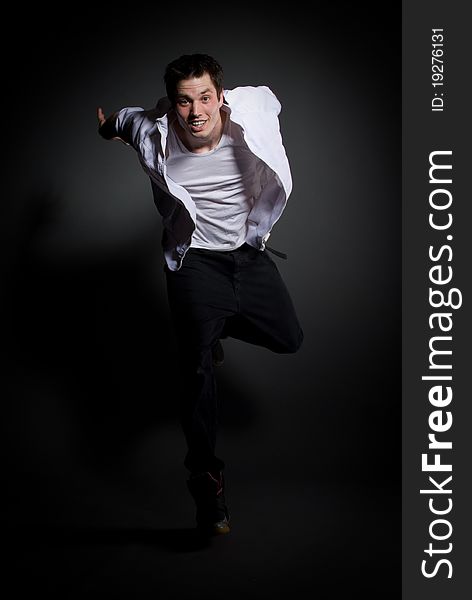 Young male dancer jumping and smiling. Young male dancer jumping and smiling